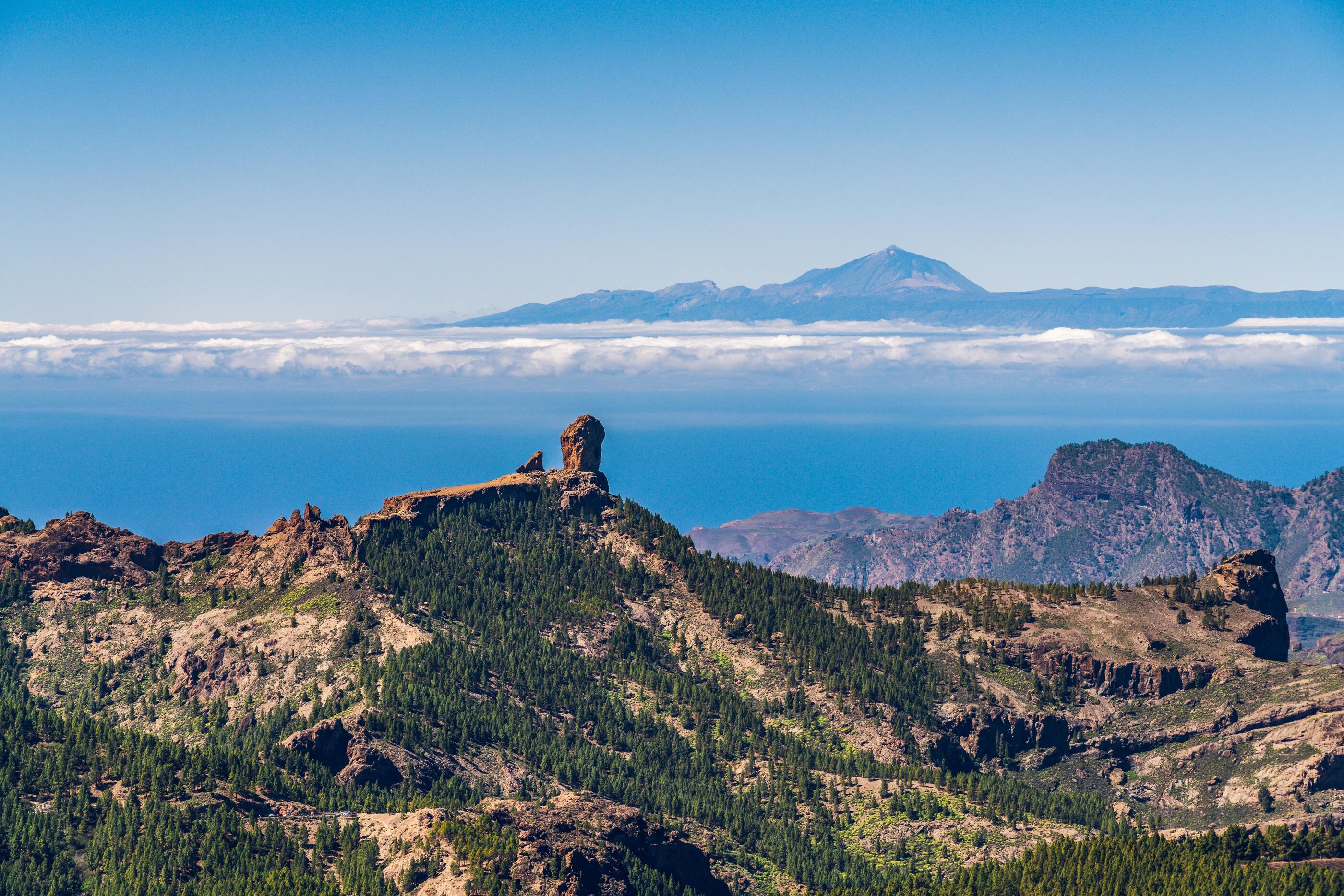 roque nublo mountain in gran canaria with the vulcano teide in the background