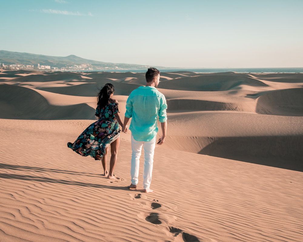 couple walking at the dunes of maspalomas